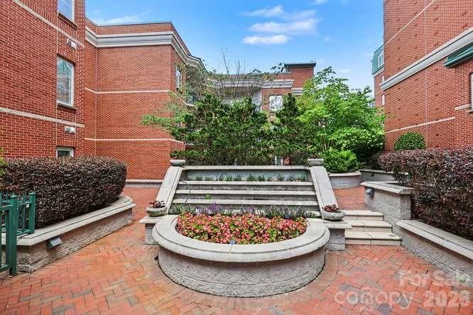 Courtyard landing with flower containers inside the 7th St gate. - 401 N Church Street, Charlotte