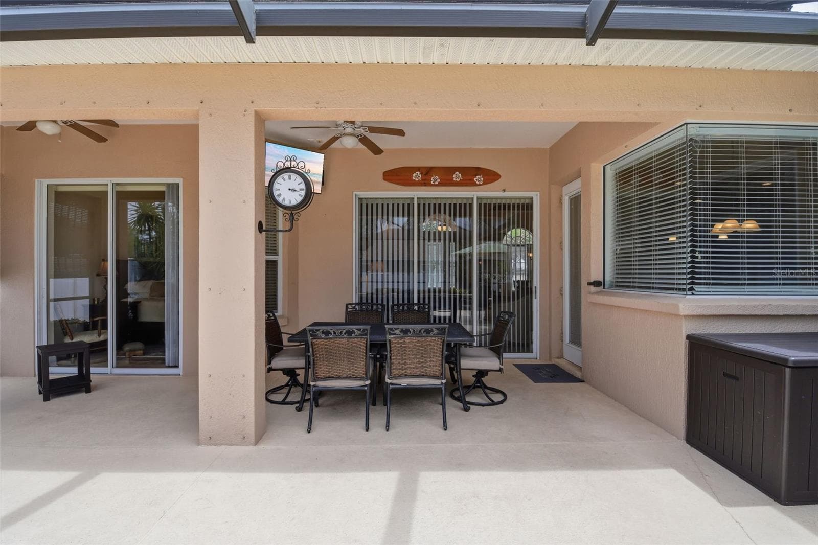 Covered Lanai – Covered lanai with ceiling fans, ample room for outdoor dining, and convenient access to the home and pool deck. - 114 VIOLA DR, AUBURNDALE