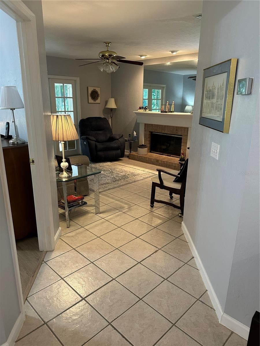 Hallway to living room and enclosed porch - 11793 CREEK DR, ALACHUA