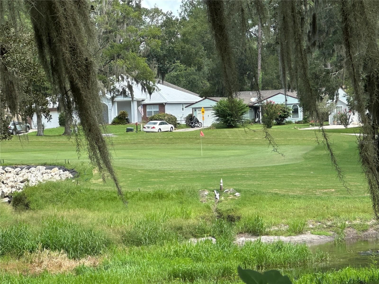 View of the 14th green from the enclosed porch - 11793 CREEK DR, ALACHUA