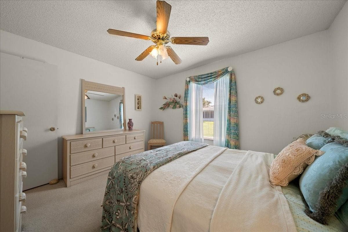 Guest Bedroom Features Ceiling Fan & Built-in Closet - 1410 SANCHEZ CT, THE VILLAGES