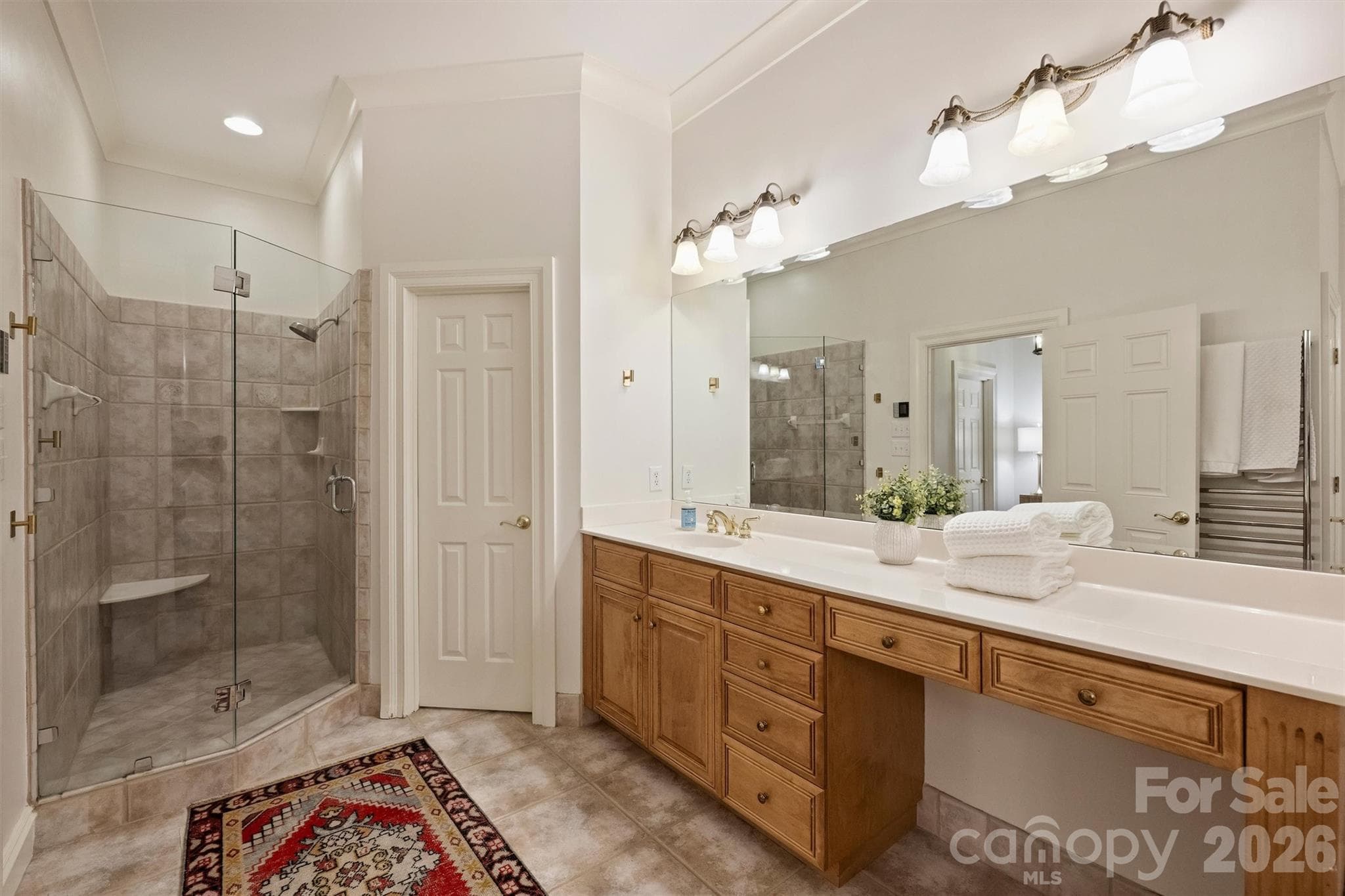 Primary Bathroom with glass walled shower, dual vanities, and tub. - 2115 Foxcroft Woods Lane, Charlotte