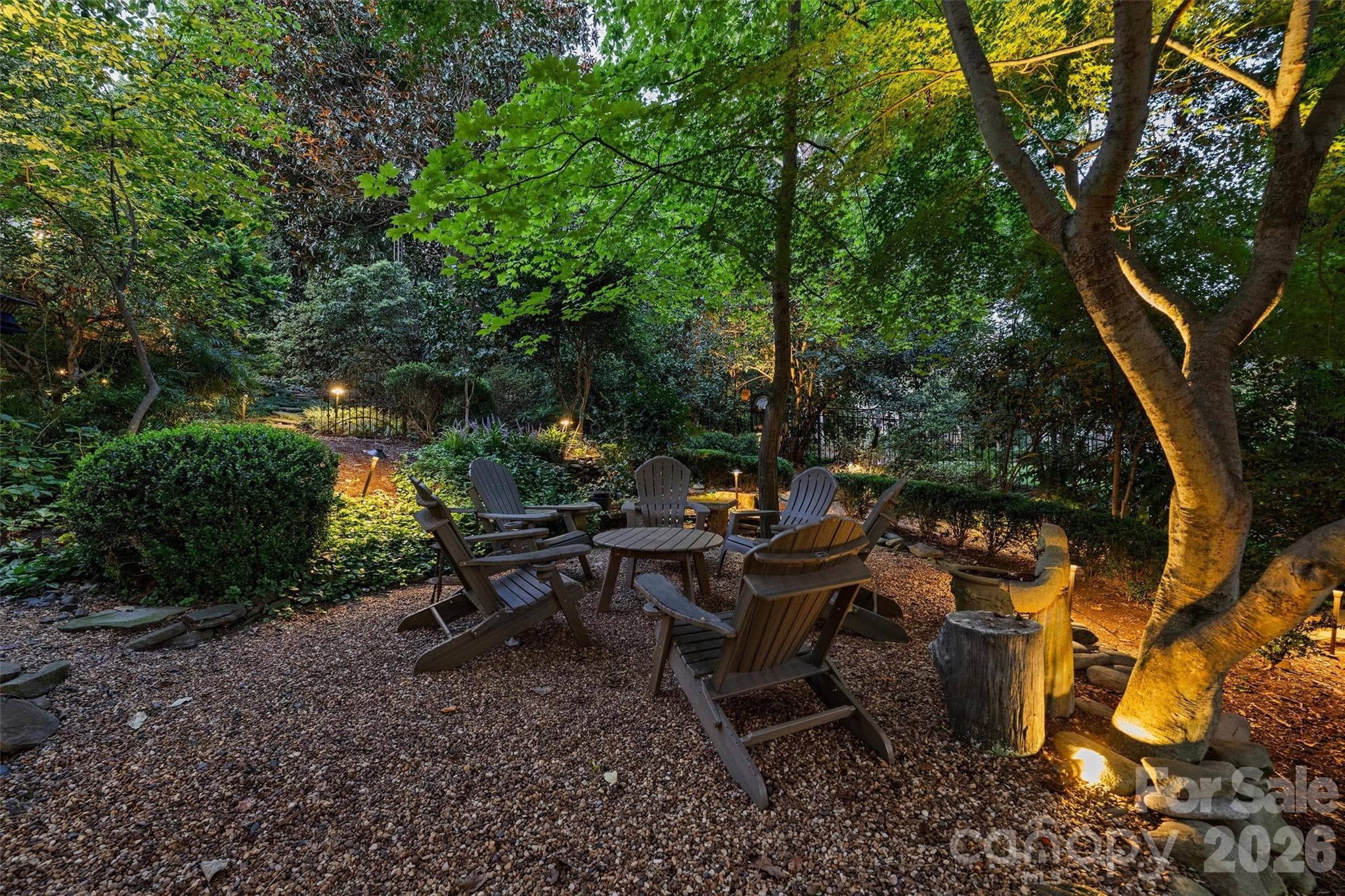 One of many backyard spots for entertaining, relaxing at day's end, or reading a book in the privacy of your own backyard, made magical with landscape lighting. - 2115 Foxcroft Woods Lane, Charlotte