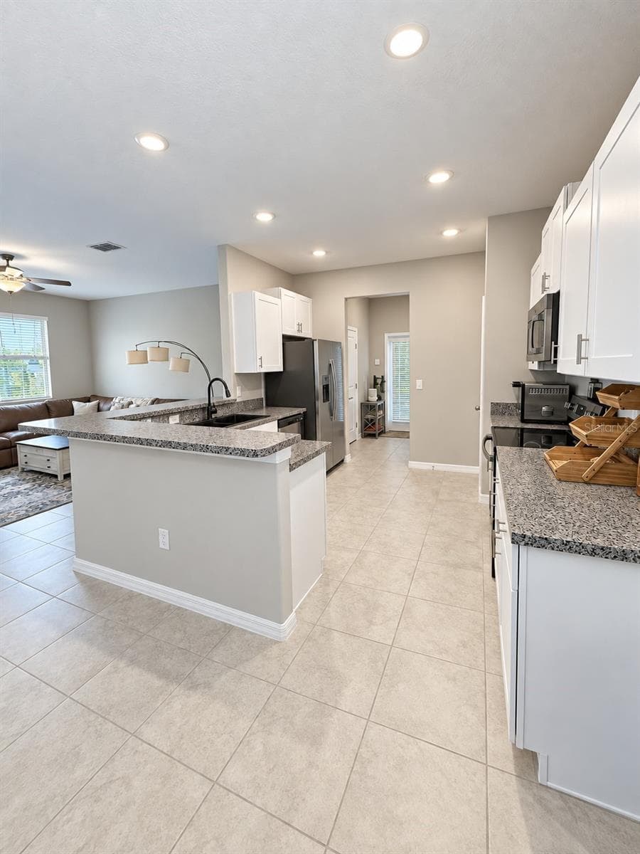 Kitchen area looking from the dining area - 9601 FLOURISH DR, LAND O LAKES