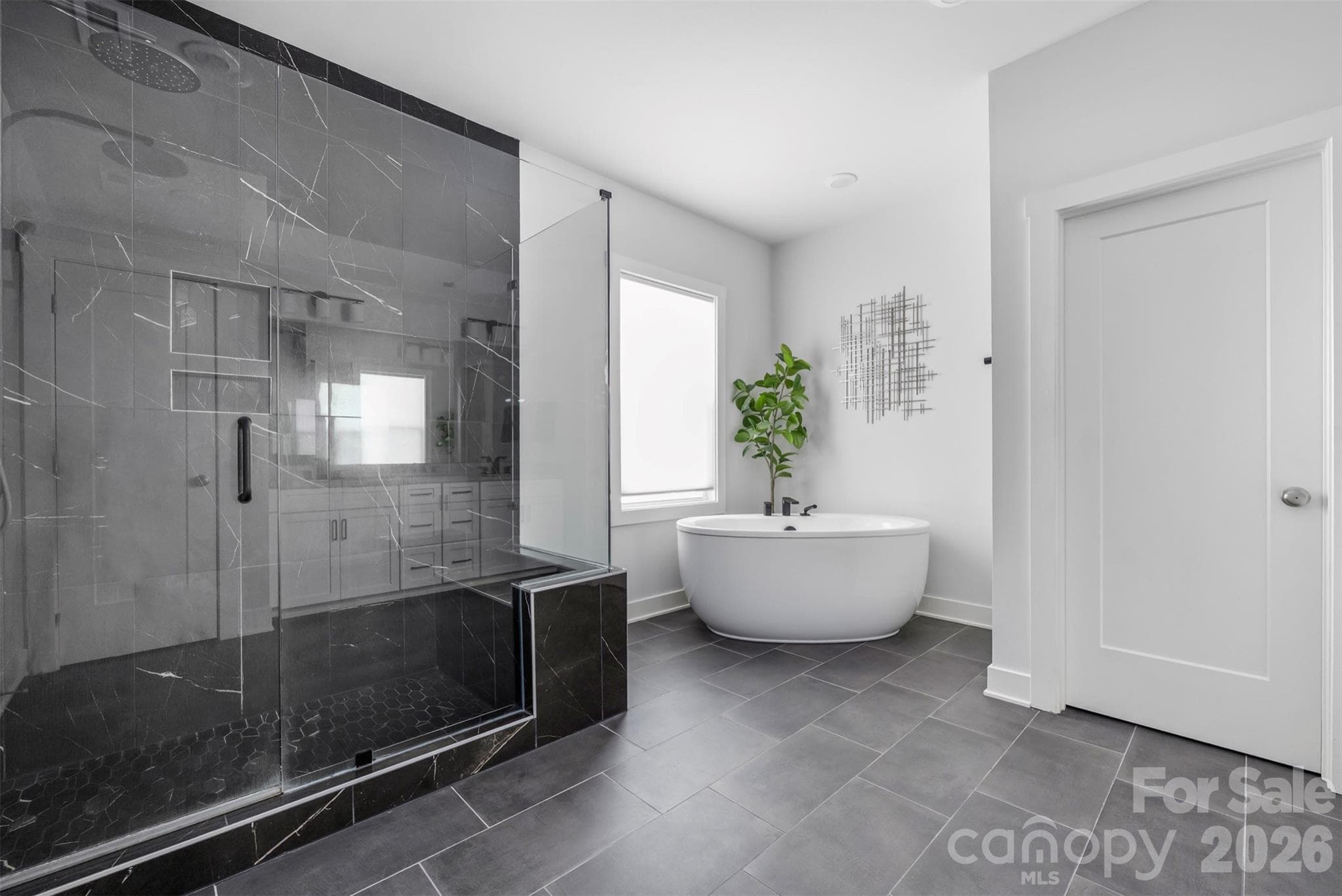 Primary bath with freestanding soaking tub and oversized black-tile shower - 4320 Tournette Drive, Indian Land