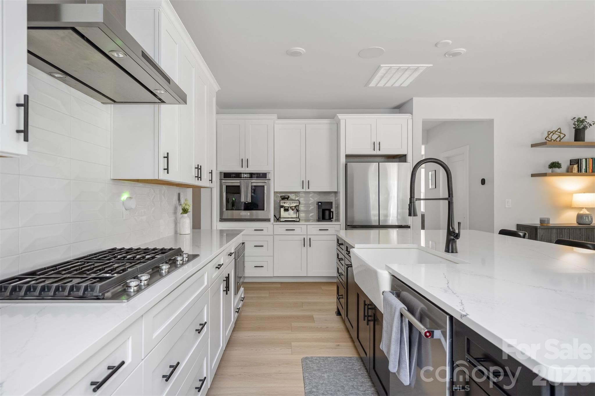 KitchenAid gas cooktop with canopy hood, wall oven, and microwave drawer - 4320 Tournette Drive, Indian Land
