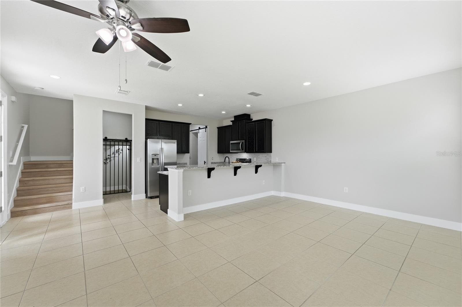 Generously sized living area with an open layout and seamless connection to the kitchen. - 2615 GIARDINO LOOP, KISSIMMEE