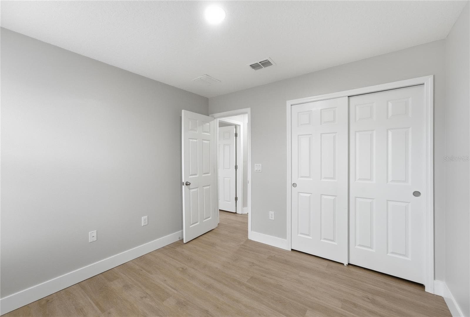 Comfortable third bedroom featuring vinyl plank flooring and a spacious closet. - 2615 GIARDINO LOOP, KISSIMMEE