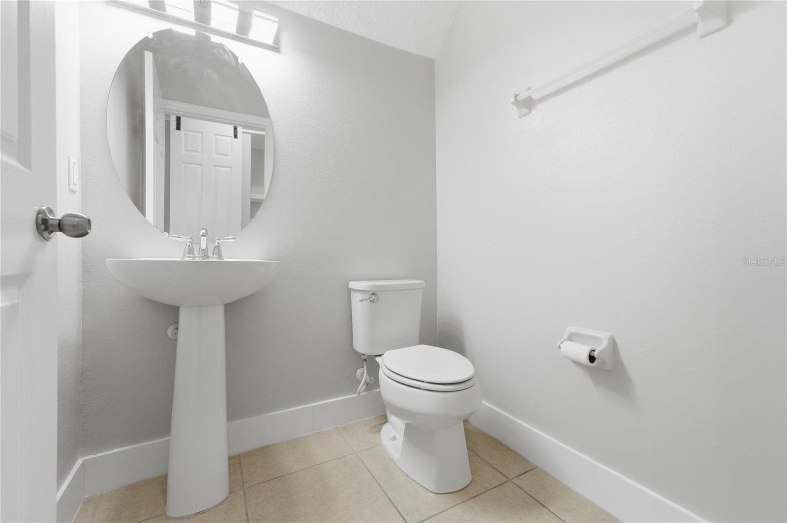 Convenient first-floor half bathroom with a pedestal sink. - 2615 GIARDINO LOOP, KISSIMMEE
