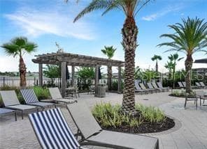Resort-style community pool deck with lounge seating, shaded areas and tropical landscaping. - 2615 GIARDINO LOOP, KISSIMMEE