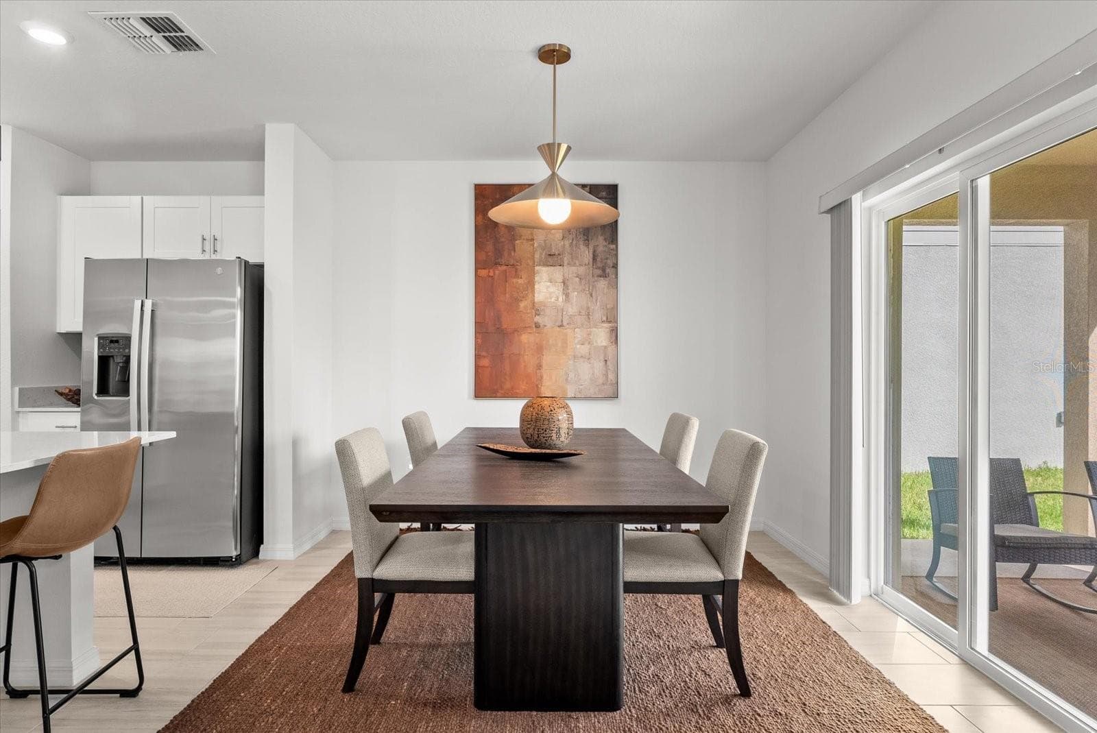 Dining area with sliding glass doors providing direct access to the backyard. - 8431 BELLA MAR TRL, PARRISH