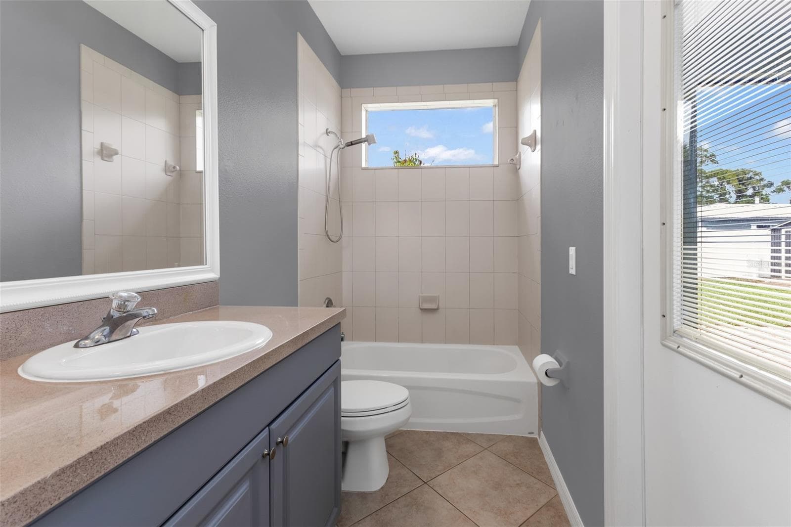 Guest bath with single vanity, shower/tub combo and access to lanai. - 2739 ATWATER DR, NORTH PORT