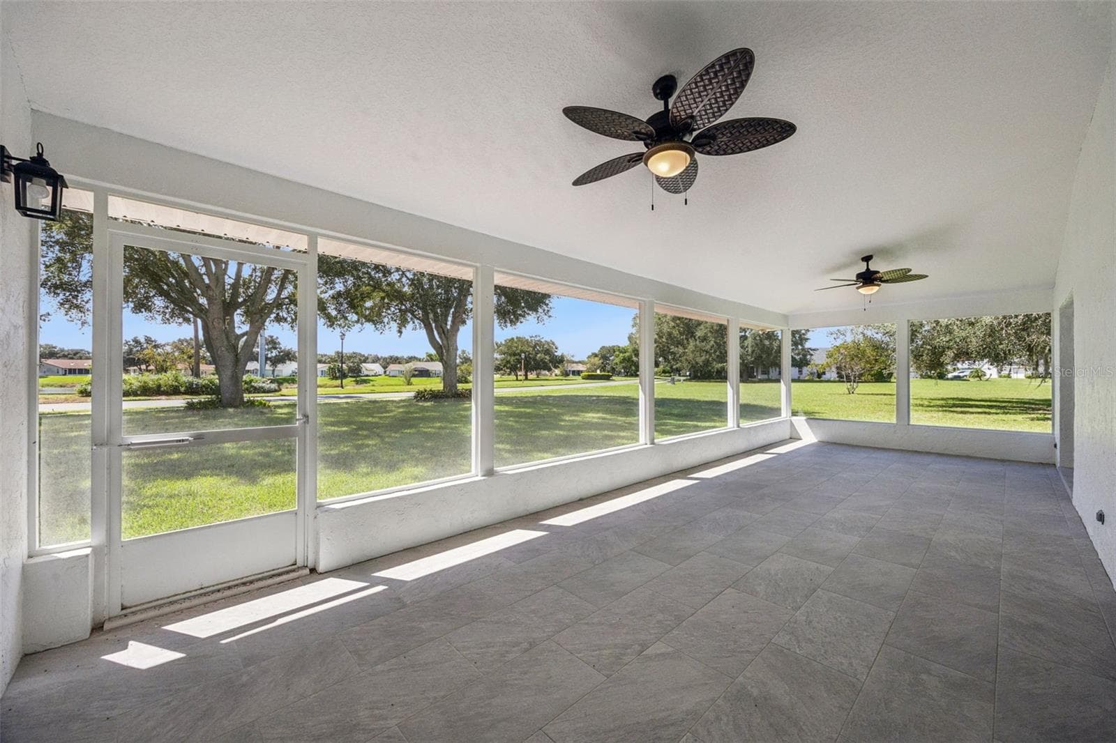 covered patio/lanai (accessible from dining/kitchen, Primary Bedroom and guest bath - 5606 LAVER ST, LEESBURG