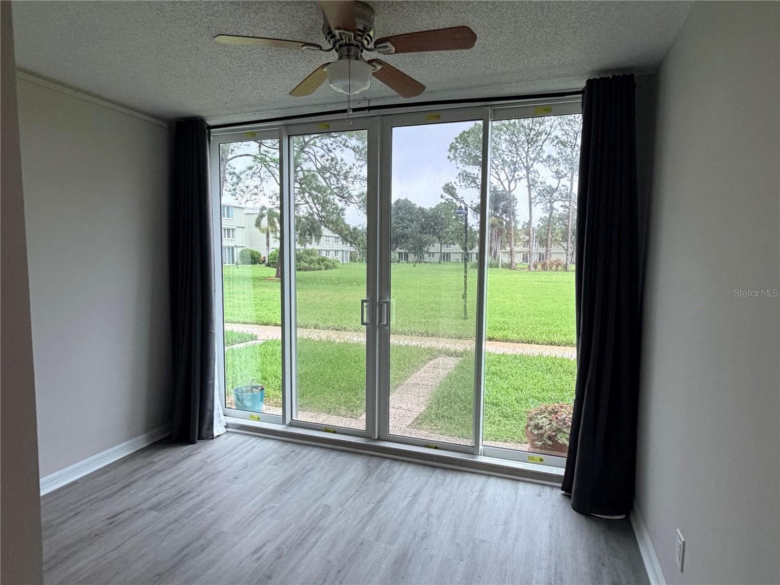 Bonus room looking out to courtyard in back of unit - 4885 1ST ST NE #117, ST PETERSBURG