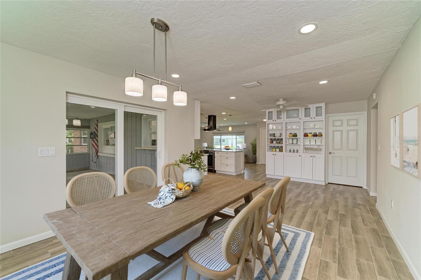 Virtually staged. Large dining room off the kitchen with built-in shelves and cabinets. - 2011 37TH ST W, BRADENTON