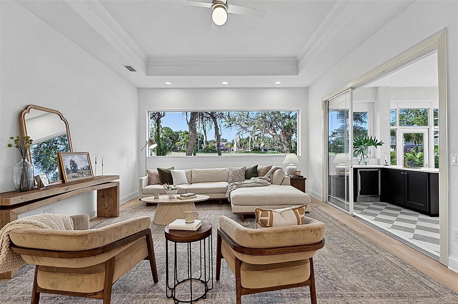 Family room with Stunning views through wall of window looking out to backyard and golf course with triple sliders onto the solarium - 17 GRANDVIEW DR, PALM COAST