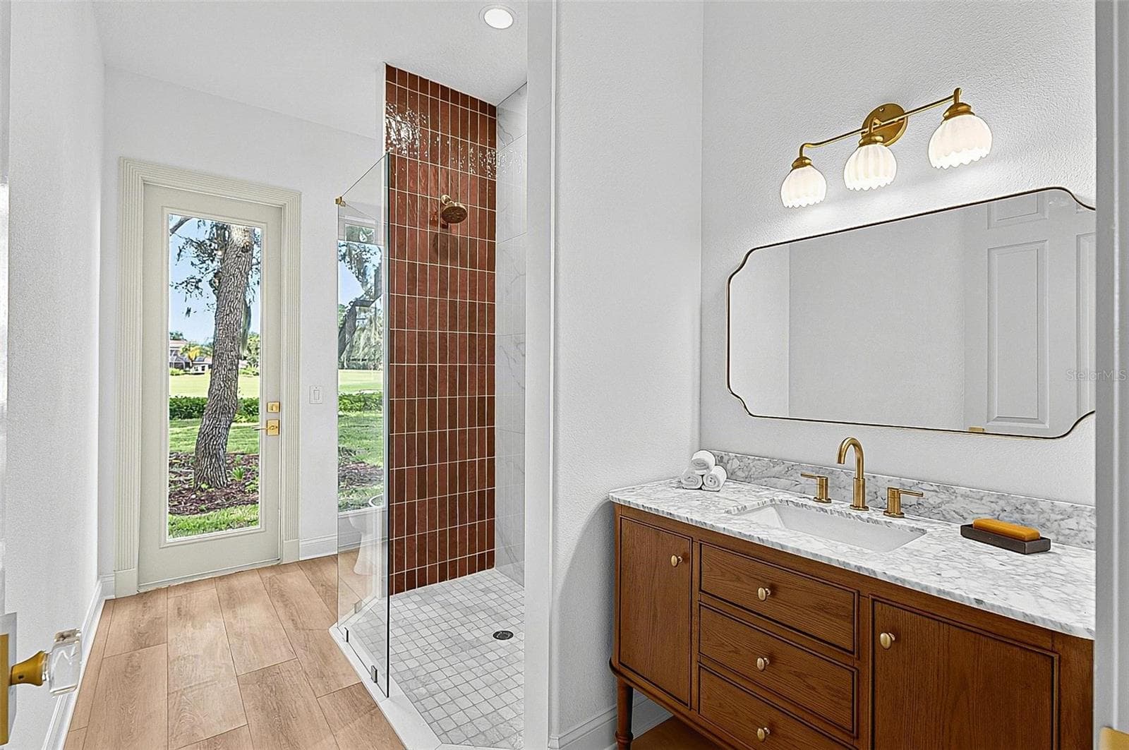 Guest 2nd bathroom with tile shower, stone top wood vanity and outside door entrance - 17 GRANDVIEW DR, PALM COAST