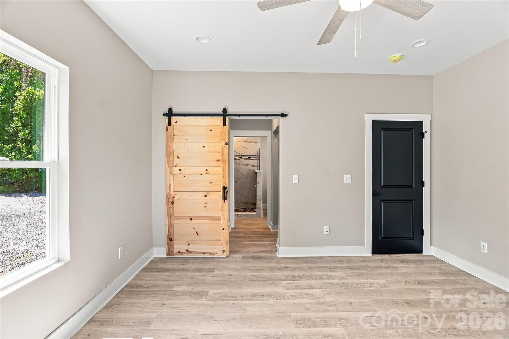 View from the primary bedroom into the primary bathroom - 156 Edwards Avenue, Swannanoa
