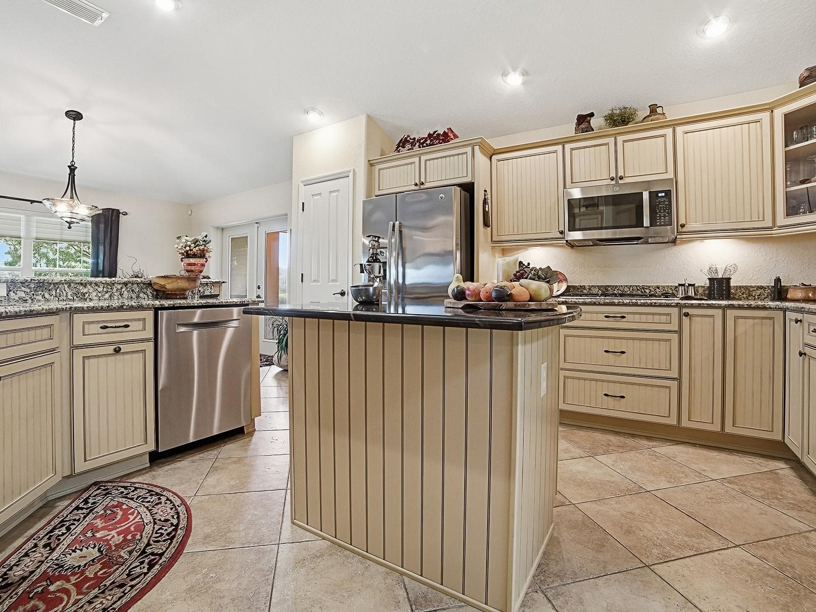 AN ISLAND FOR ADDED COUNTER SPACE AND WORK AREA - 1089 VANCE TRL, THE VILLAGES