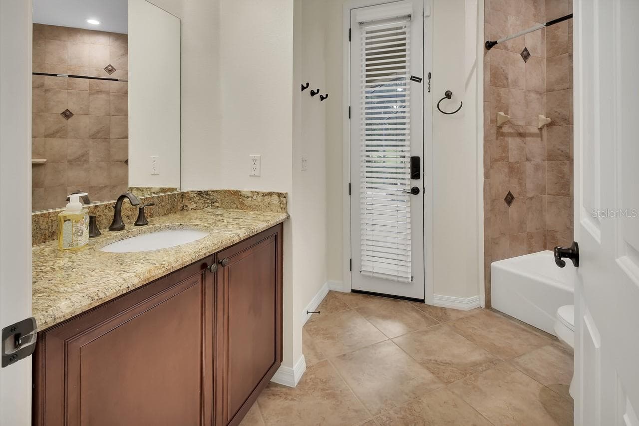 Bathroom 2 leads out to the pool. - 502 VICTORIA HILLS DR, DELAND