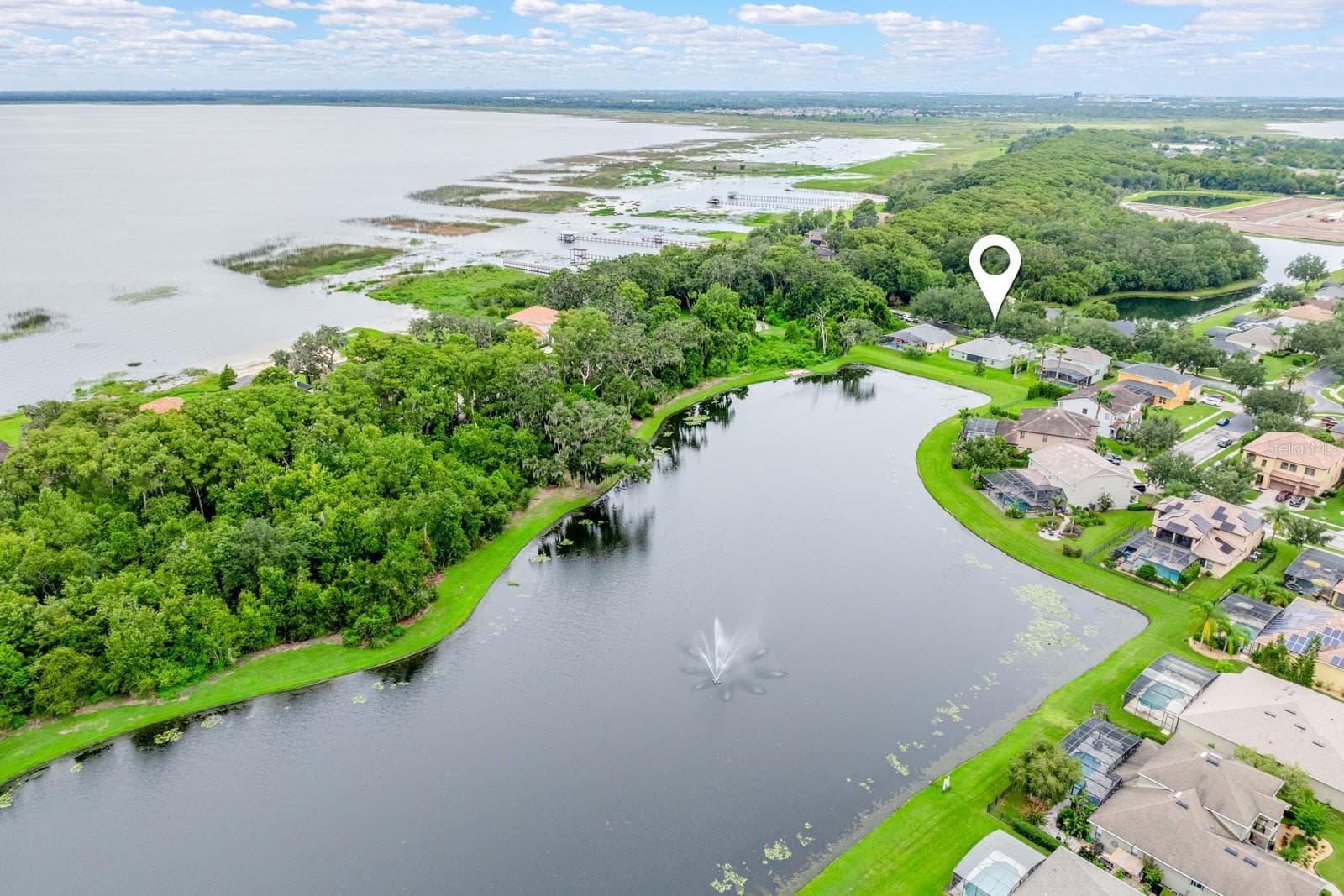 Premium pond lot with East Lake Toho in the background. - 4946 LAZY OAKS WAY, ST CLOUD