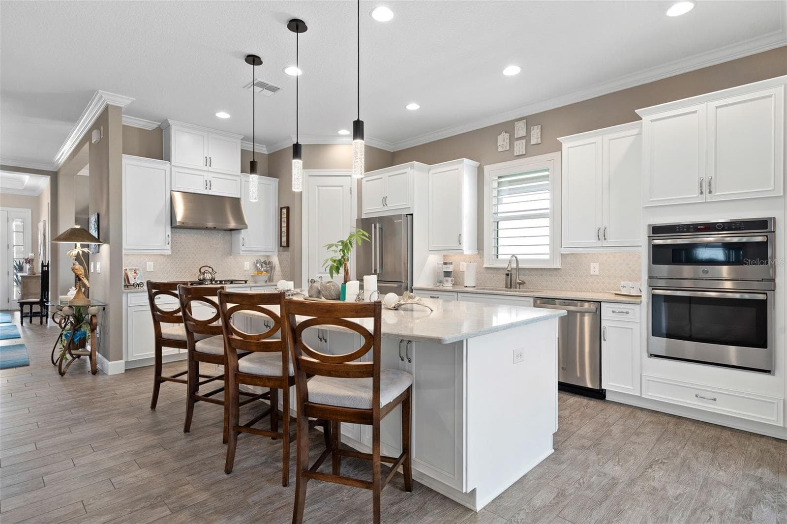 This Lazio model features the gourmet Kitchen option with an upgraded built-in cooktop, microwave and oven. The Quartz Countertops, upgraded cabinetry with pull-out shelves and front facing island cabinets offer ample storage. - 1279 ZEEK RIDGE ST, CLERMONT