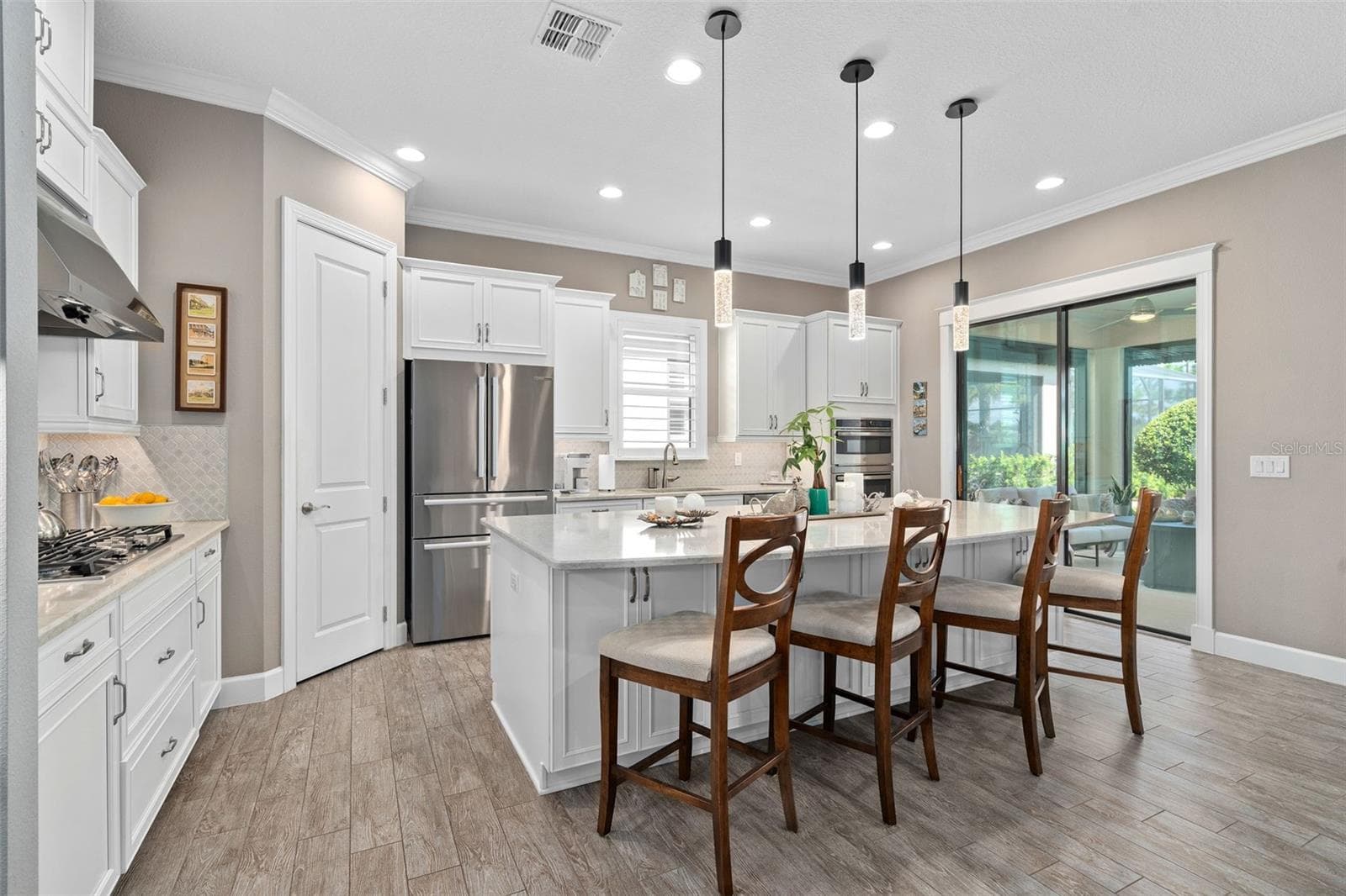 Under cabinet lighting grace the Quartz Countertops and the ceramic backsplash. - 1279 ZEEK RIDGE ST, CLERMONT