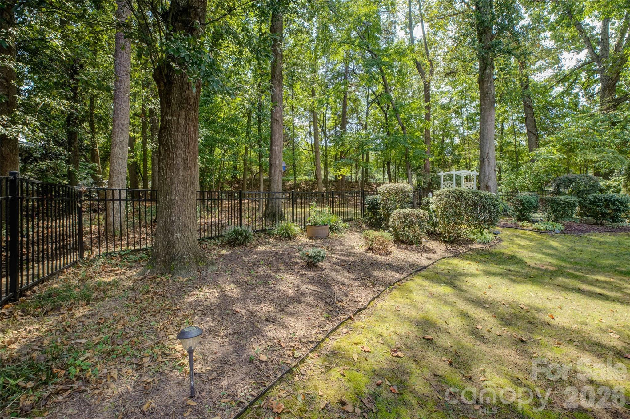 The backyard extends beyond the current fence line. - 946 Lake Club Drive, Rock Hill