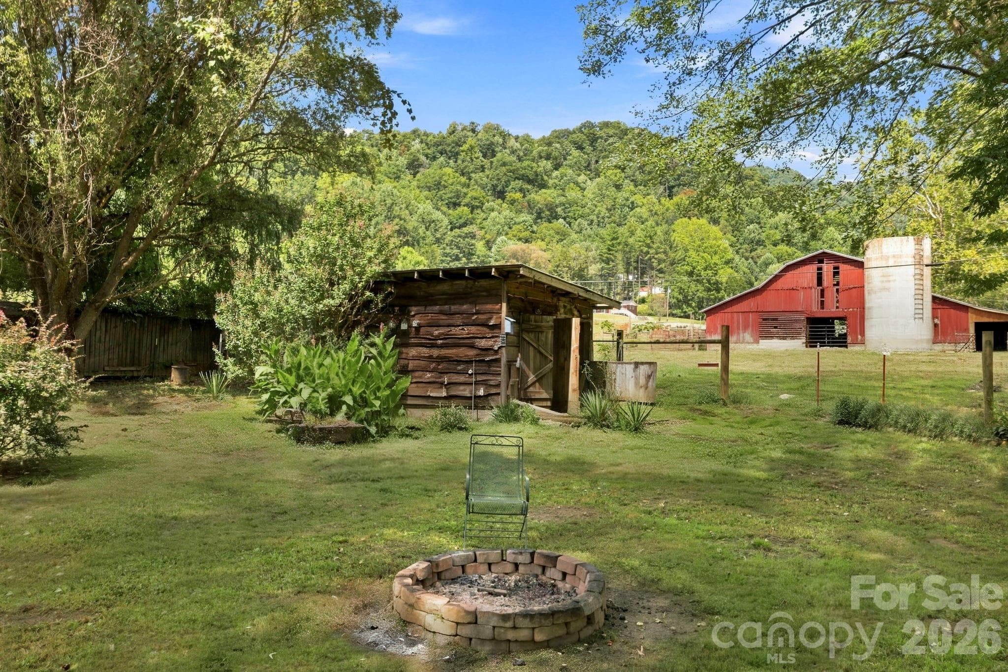 Outbuilding #1 in background of firepit - 10687 Cruso Road, Canton