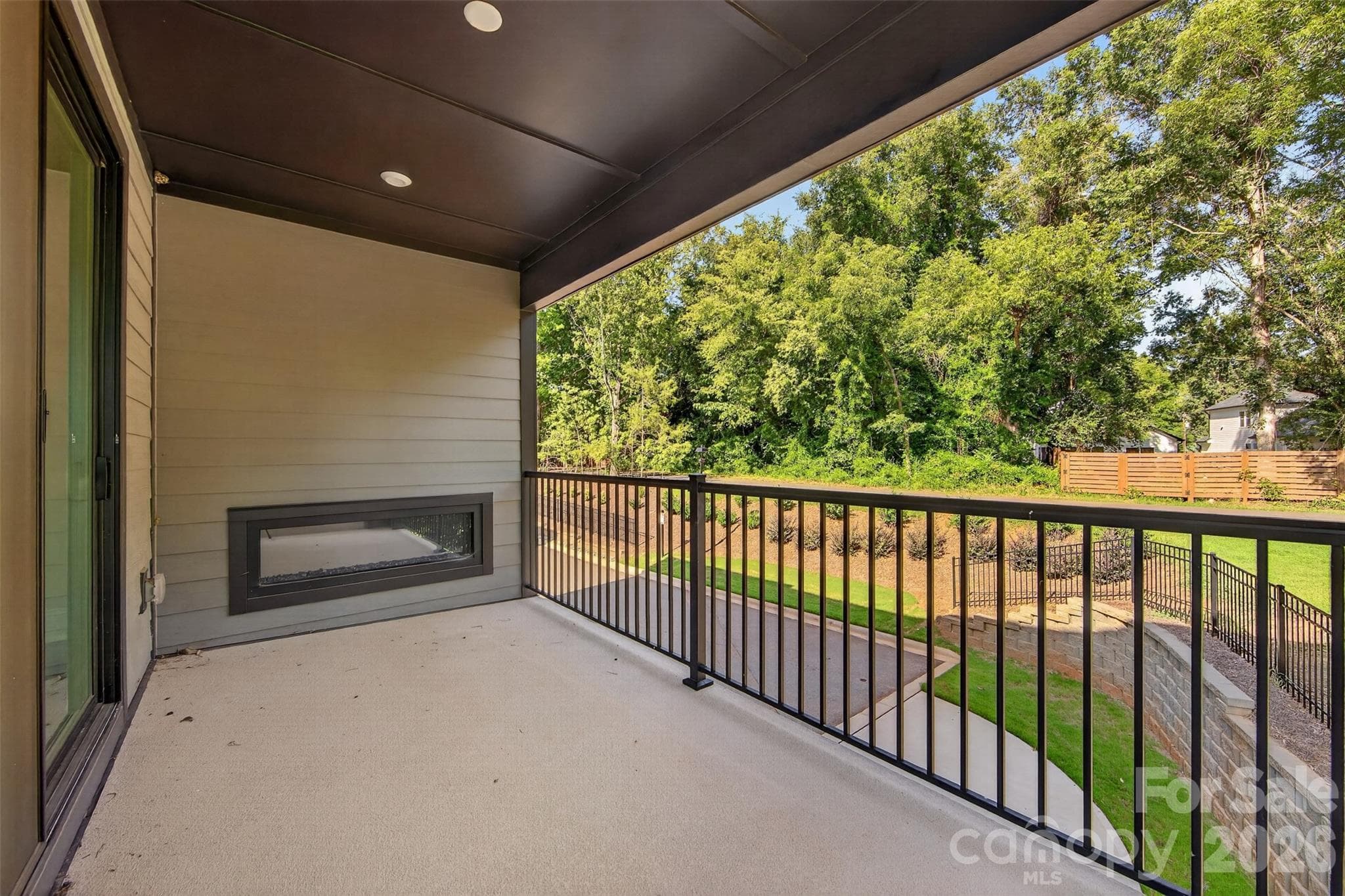 Covered outdoor living with an electric fireplace - 411 Old Town Village Road, Waxhaw