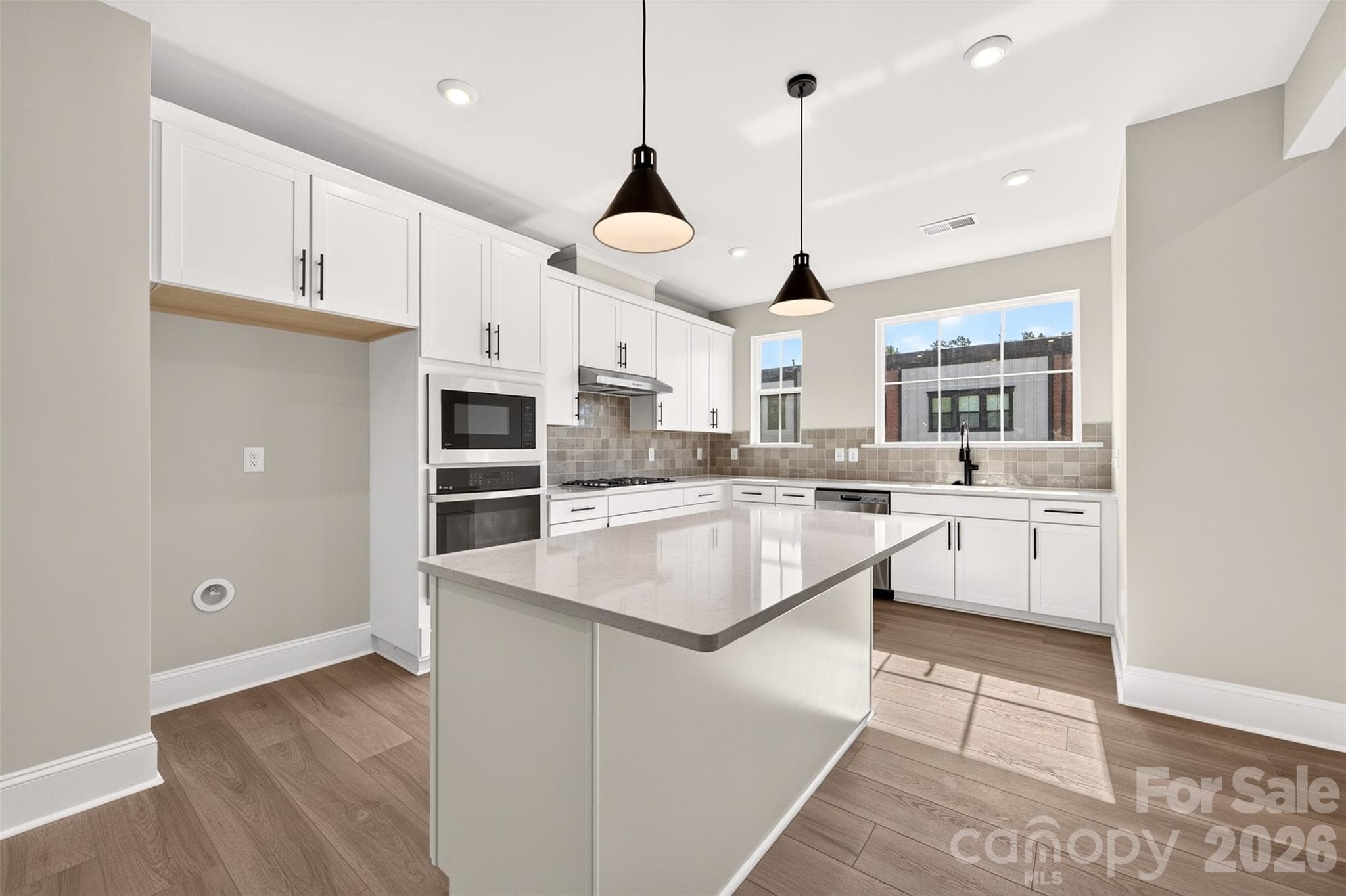 Light filled gourmet kitchen with large windows - 411 Old Town Village Road, Waxhaw