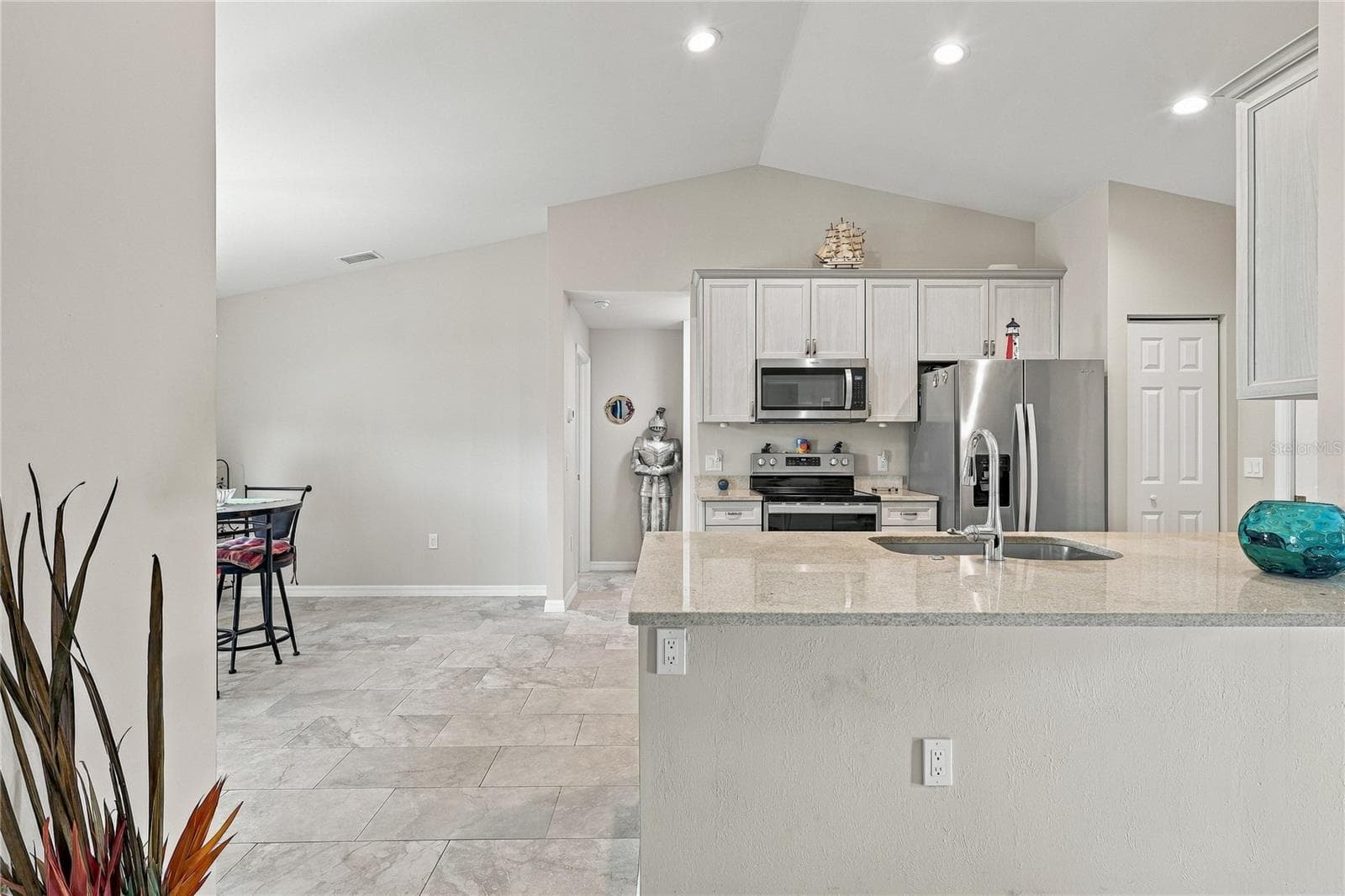 KITCHEN WITH BREAKFAST BAR AND RECESSED LIGHTING - 10554 LIVE OAK RD, PORT CHARLOTTE