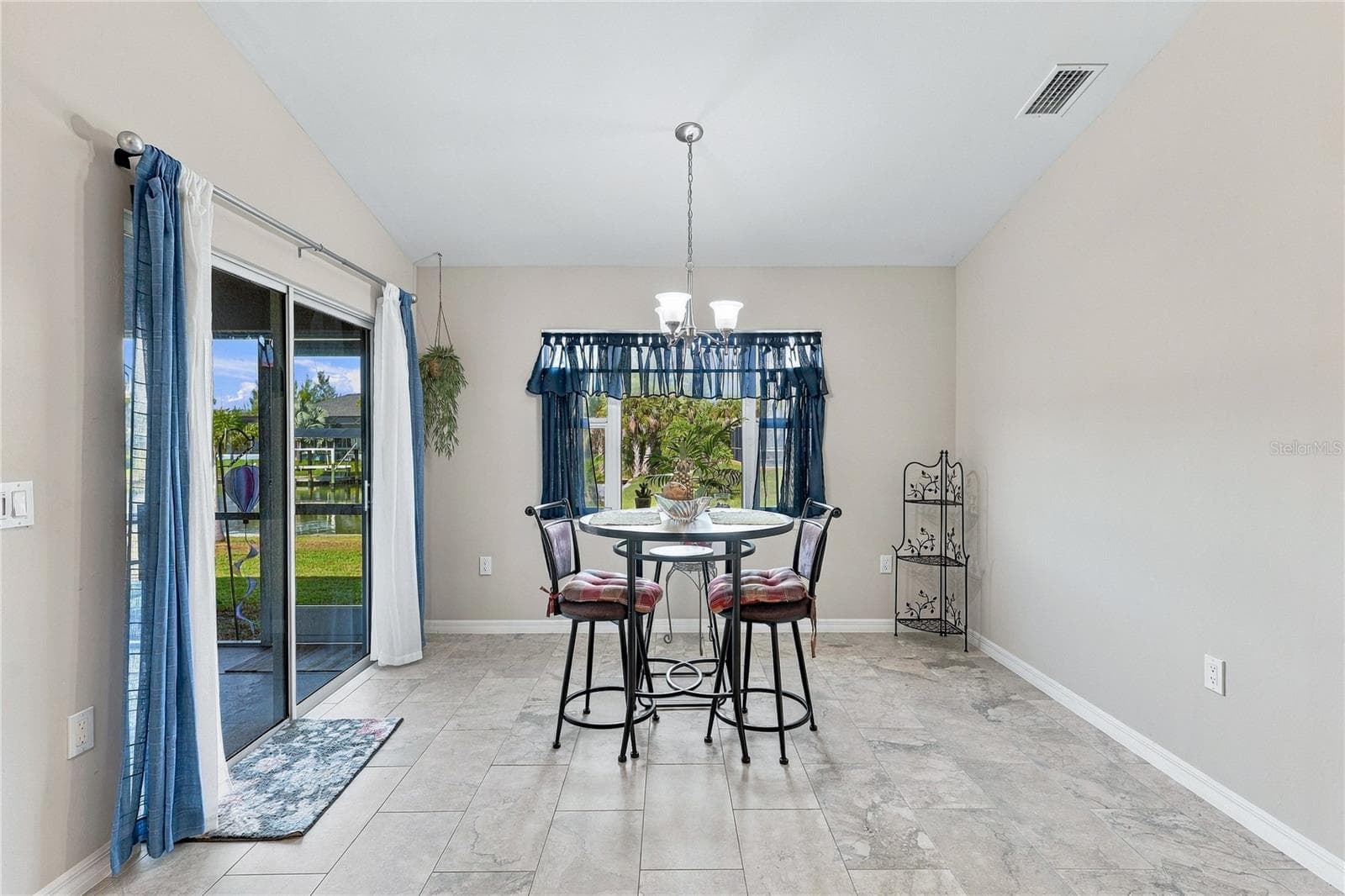 DINING AREA WITH VIEW OF CANAL. LIGHT AND AIRY - 10554 LIVE OAK RD, PORT CHARLOTTE