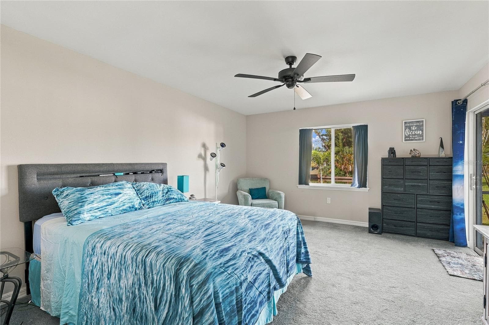 PRIMARY BEDROOM LIGHT AND BRIGHT WITH VIEW OF LANAI AND CANAL - 10554 LIVE OAK RD, PORT CHARLOTTE