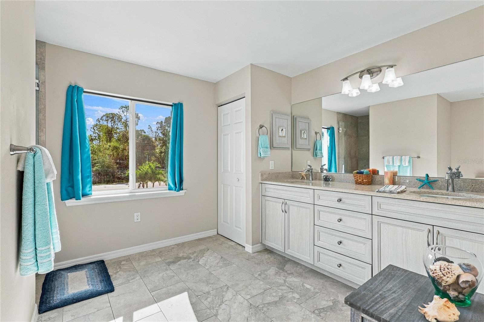 SPACES PRIMARY BATH WITH TILE, STONE COUNTERS AND TILED WALK IN SHOWER. LIGHT AND BRIGHT WITH DUAL SINKS. - 10554 LIVE OAK RD, PORT CHARLOTTE