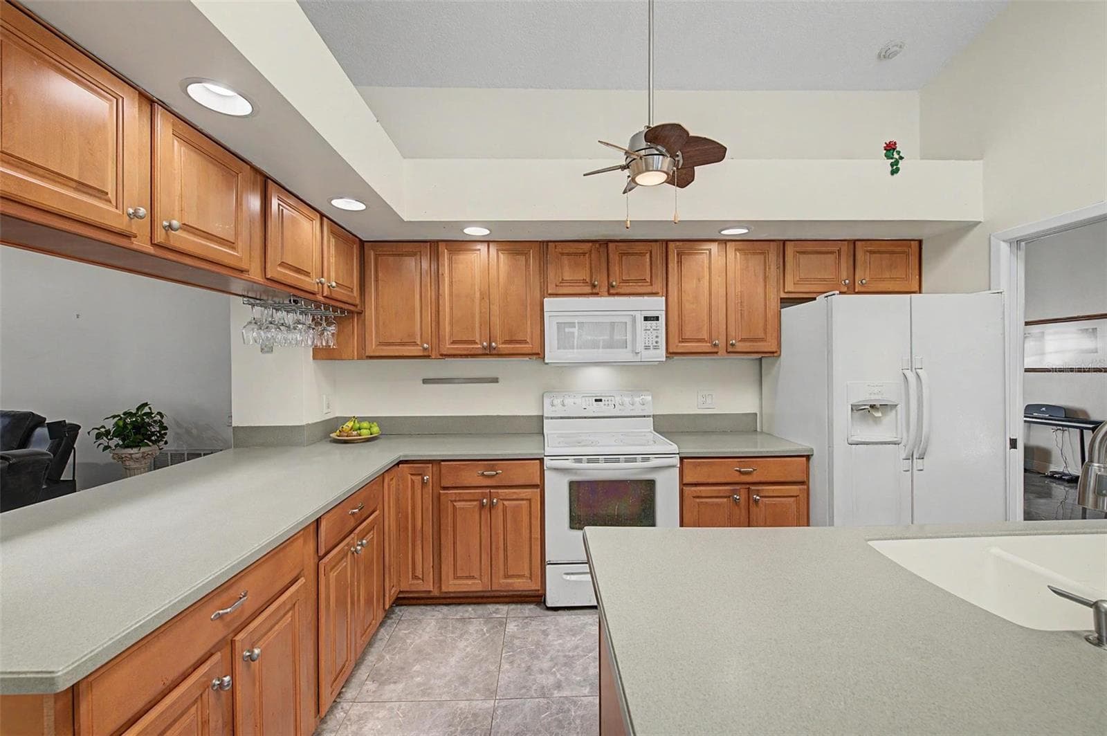 Kitchen with 2 skylights and eating area with 2 slider doors to the pool area. - 8612 BRAXTON DR, HUDSON