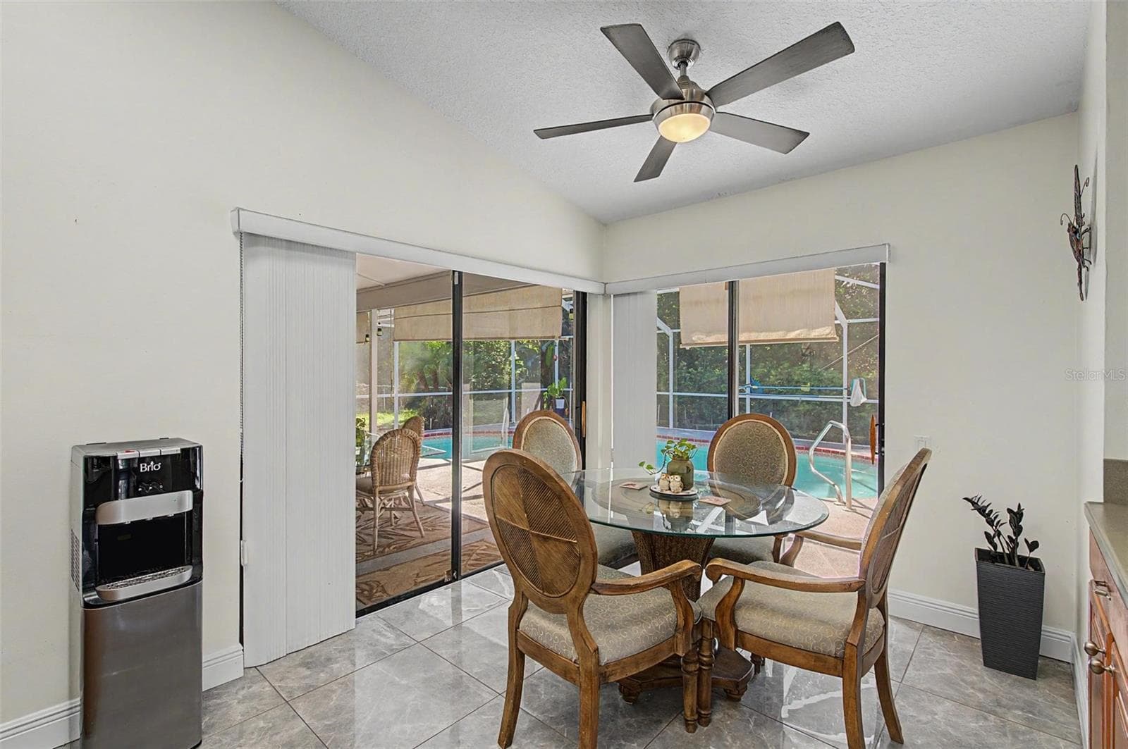 Kitchen with 2 skylights and eating area with 2 slider doors to the pool area. - 8612 BRAXTON DR, HUDSON