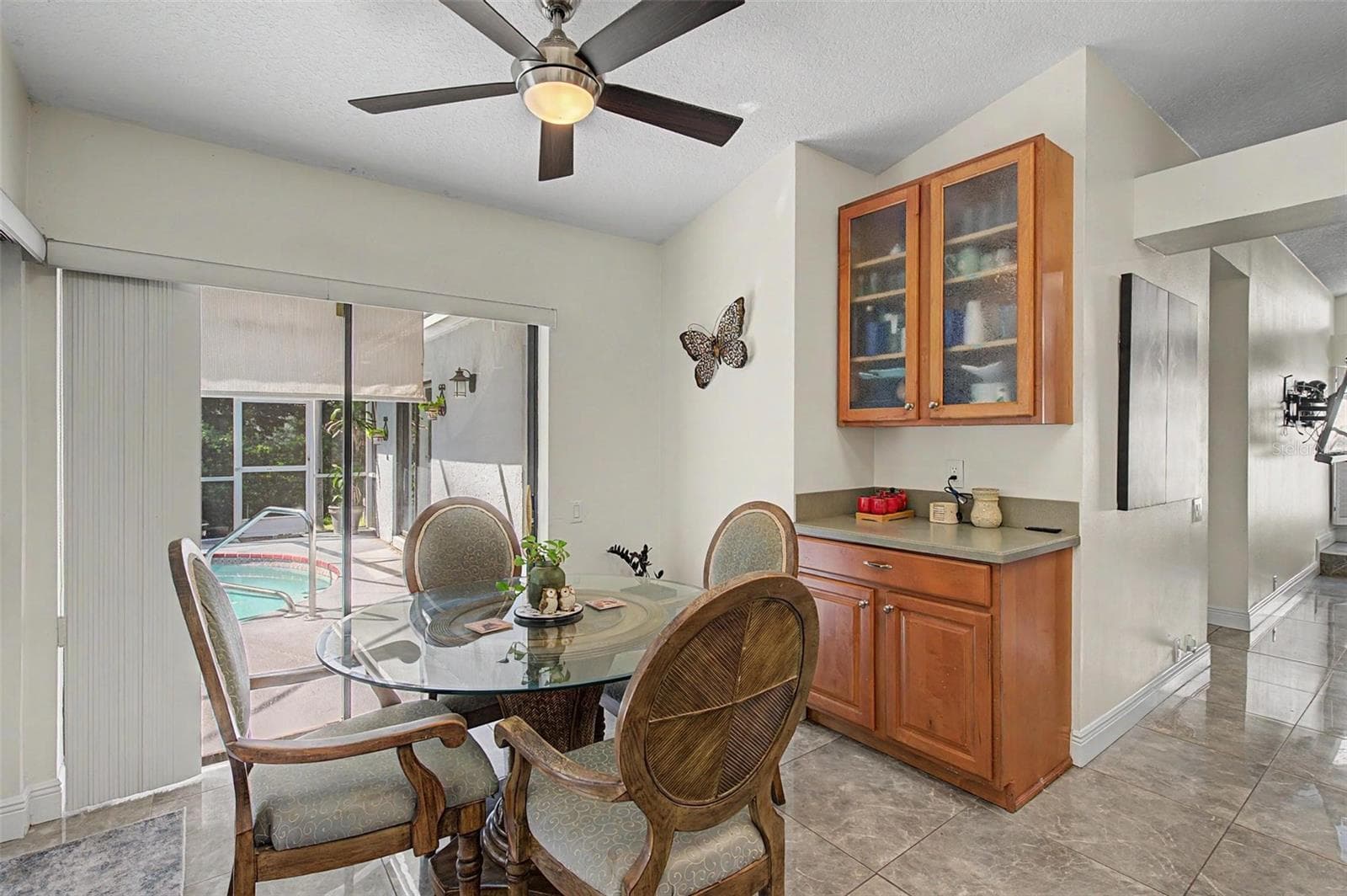 Kitchen with 2 skylights and eating area with 2 slider doors to the pool area. - 8612 BRAXTON DR, HUDSON
