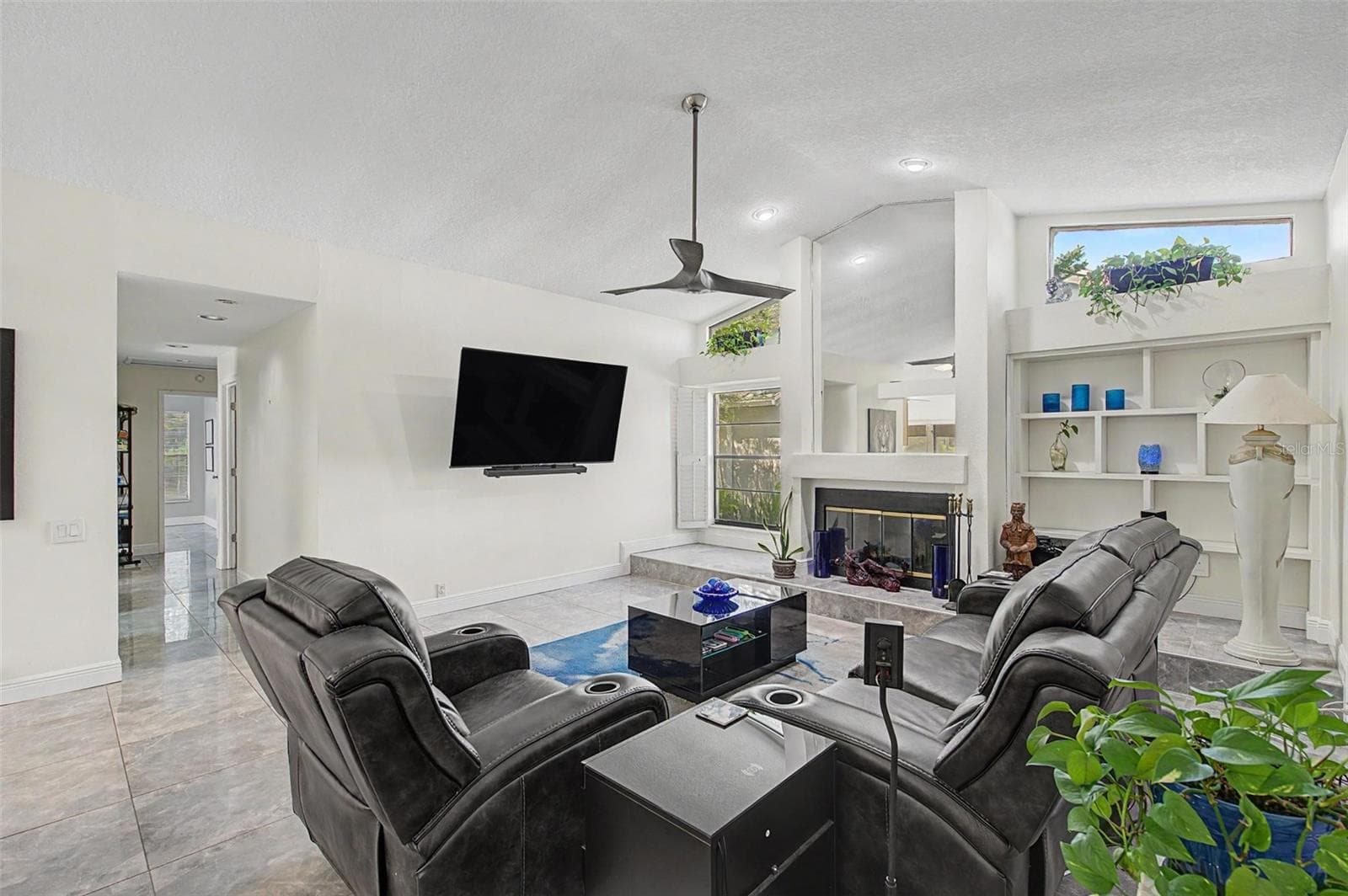 Family Room with fireplace and open shutters - 8612 BRAXTON DR, HUDSON