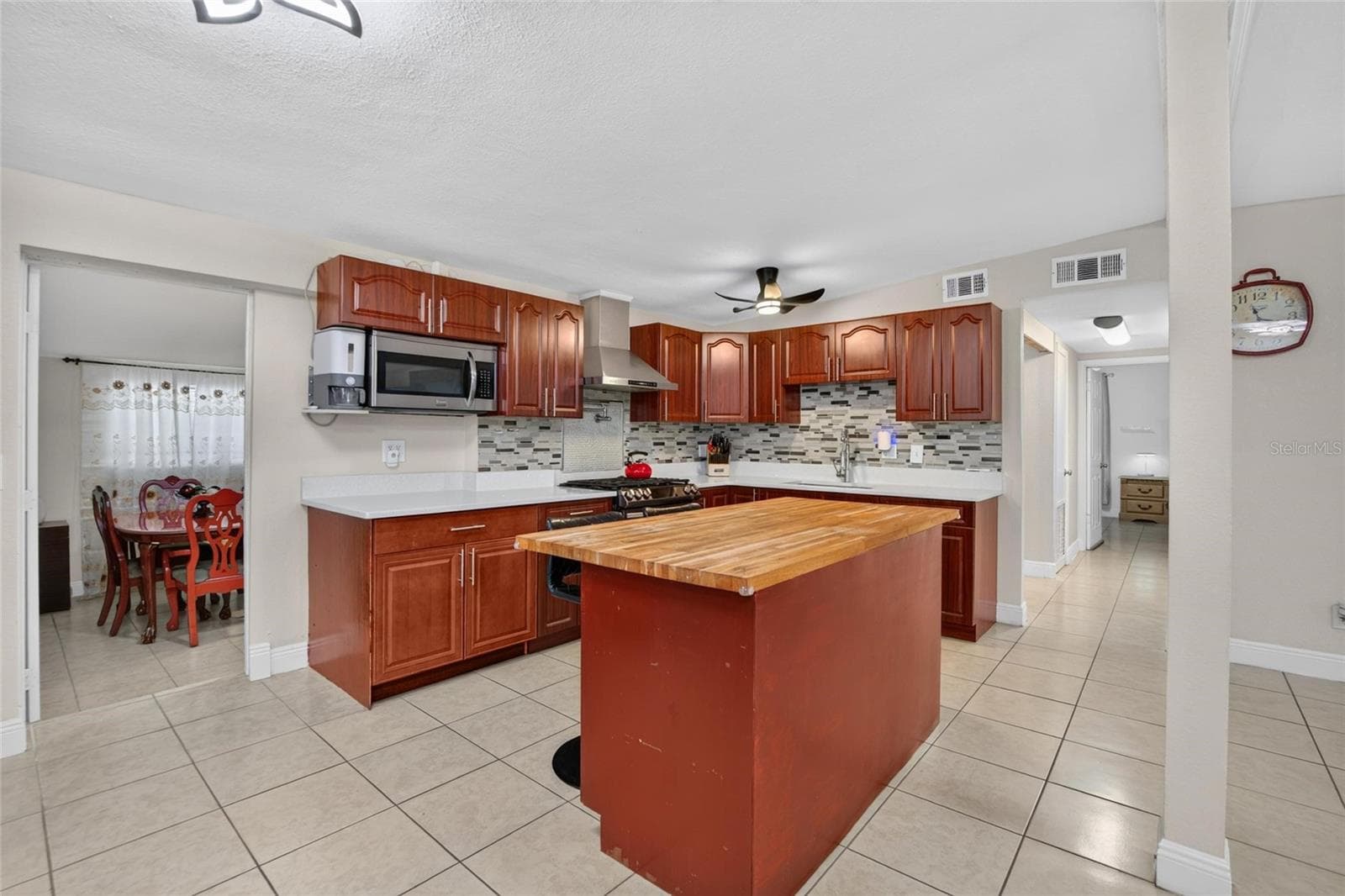 Bright kitchen with Quartz countertops. Doorway to the left shows a sunken room which is technically a bedroom but is being used as a dining room. - 1727 WAIKIKI WAY, TAMPA