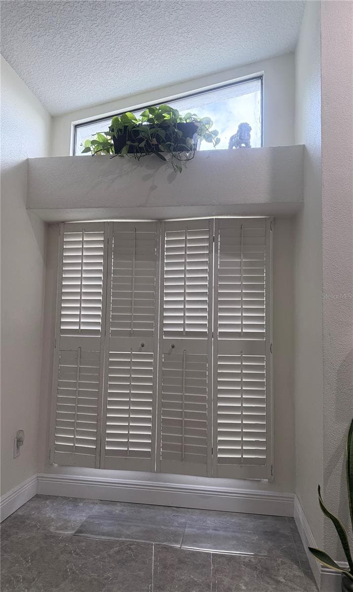 Closed shutters in family room with fireplace - 8612 BRAXTON DR, HUDSON
