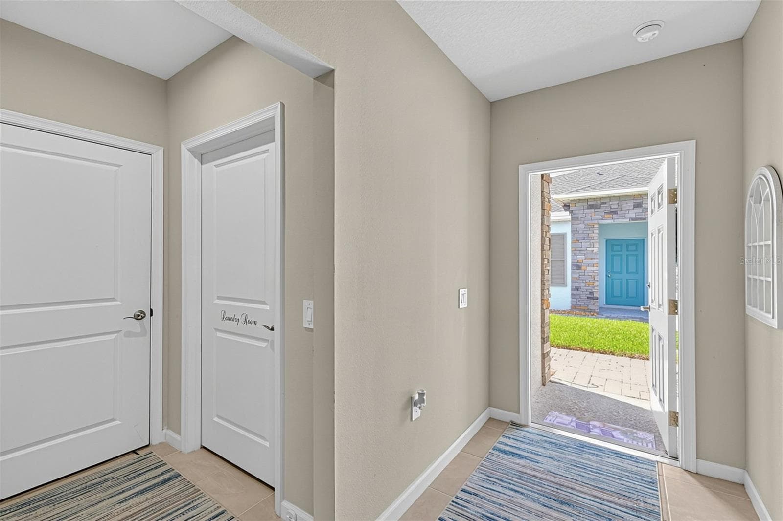 front door and laundry - 16363 COCONUT PALM DR, PORT CHARLOTTE