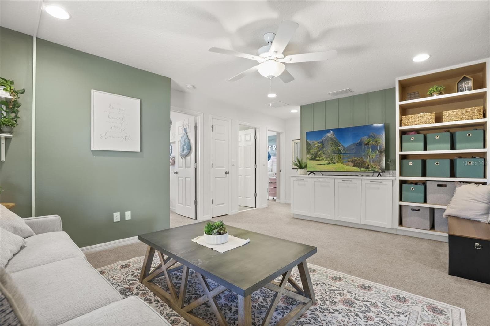 Another view of the upstairs loft, showcasing the built-in cabinetry and flexible living space. - 7104 DILLY LAKE AVE, GROVELAND