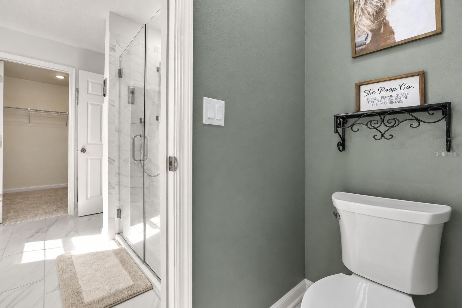 Another view of the primary bathroom, showing the private toilet area and walk-in shower. - 7104 DILLY LAKE AVE, GROVELAND