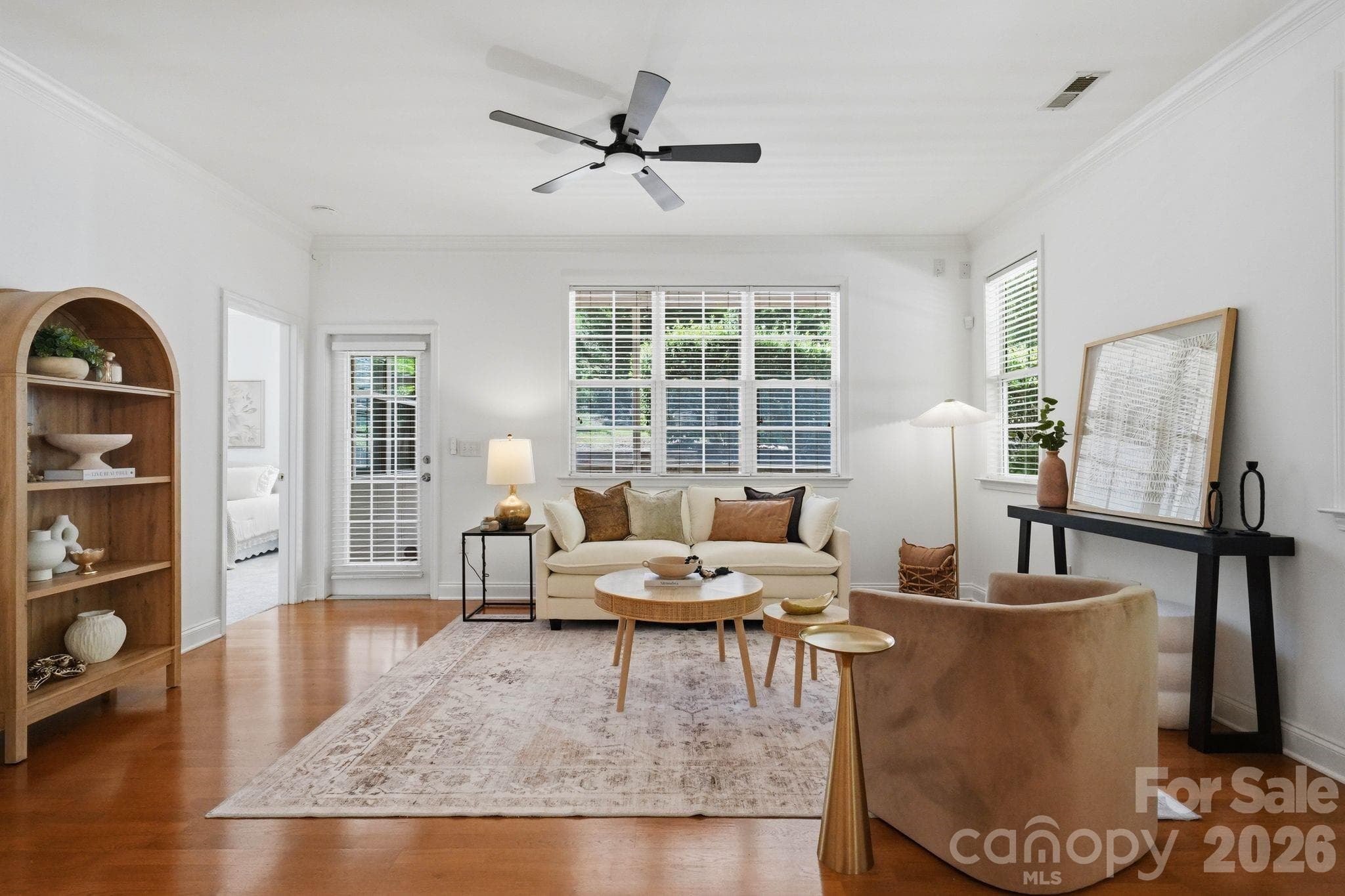 Comfortable family room with generous wall space, natural light, and direct access to the screened porch. - 18810 Cloverstone Circle, Cornelius