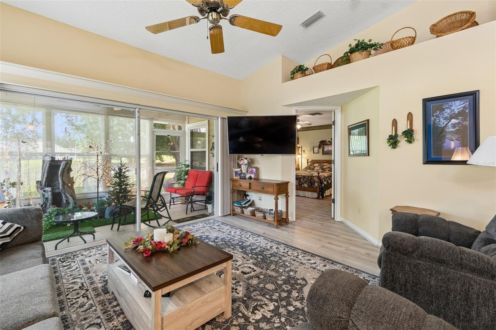Living room with view to primary bedroom - 5213 LOCHMEAD TER, ZEPHYRHILLS