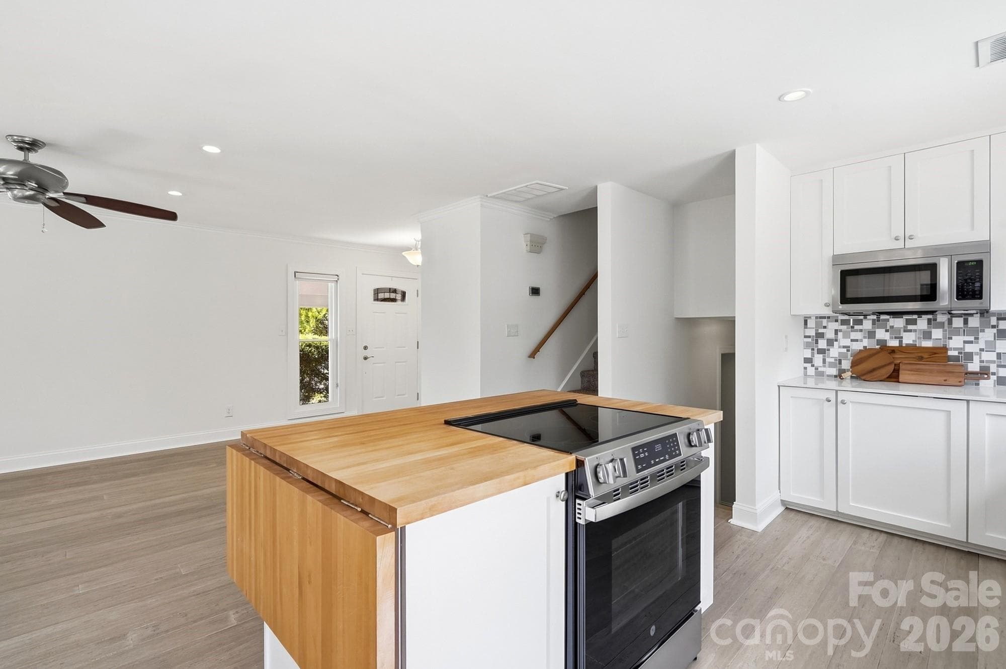 Stylish butcher block island adds warmth and character to the kitchen, with plenty of space for meal prep and gathering. - 3022 Point Clear Drive, Tega Cay