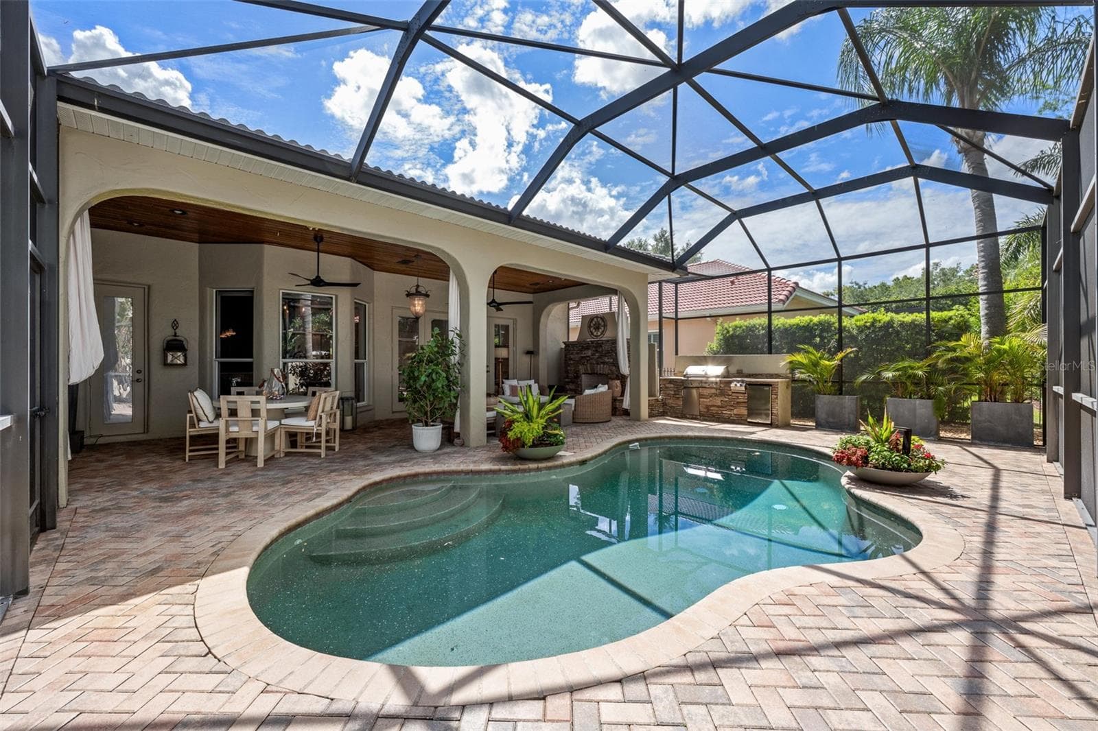 Pool — Free-form pool with paver surround and view of the covered lanai. - 1921 FLORESTA VIEW DR, TAMPA