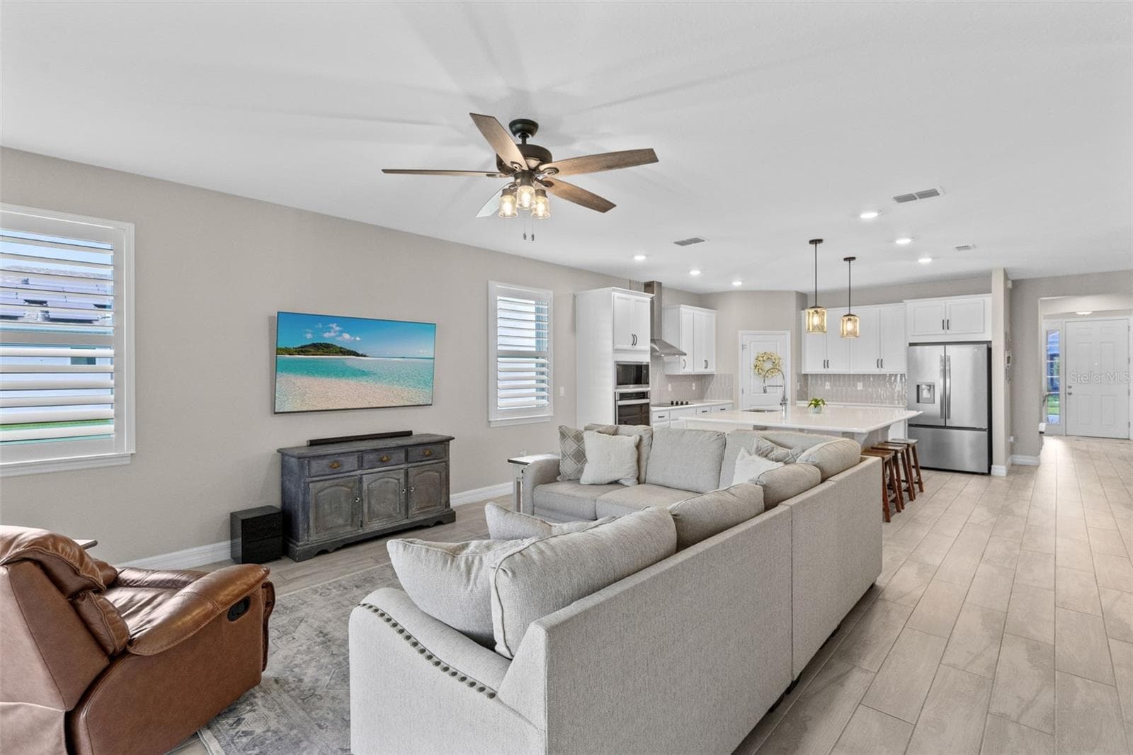 Family Room, kitchen. Home also offers custom shutters on all windows - 1274 SILO DR, ST CLOUD