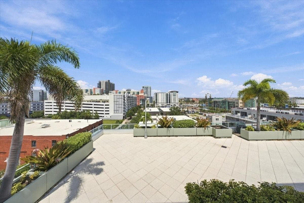 Expansive open-air deck offering scenic palm-framed views and ample space for outdoor relaxation or entertaining. - 111 N 12TH ST #1704, TAMPA